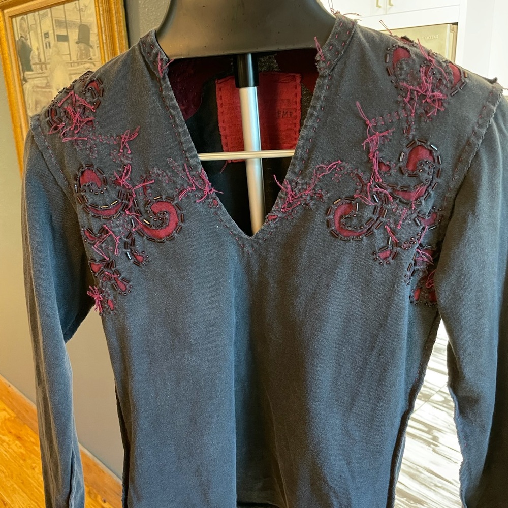 Wonderfully distressed sustainably made top.